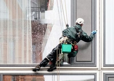 man cleaning exterior window